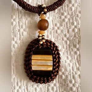 Fashion necklace with pearl shell accents of woven rattan material